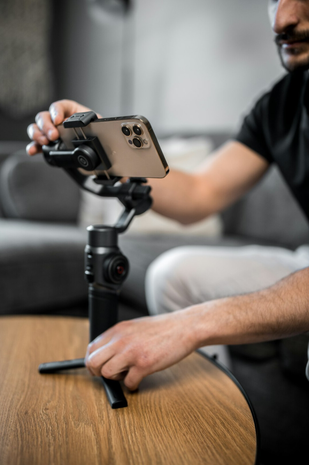 Young creator filming vertical video with a smartphone on a gimbal