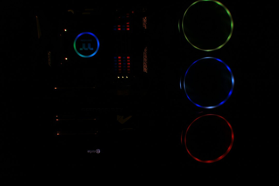 Colorist grading footage with scopes and color wheels on a monitor